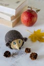 Ceramic handmade hedgehog in autumn theme on a table