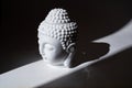 Ceramic head of Buddha statue in the ray of light. Royalty Free Stock Photo