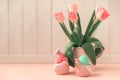 Ceramic hen, Easter eggs and vase with tulips on pink wooden table. Easter celebration concept. Soft focus Royalty Free Stock Photo