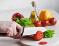 Ceramic knife cutting tomatoes for salad