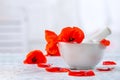 Ceramic, mortar and pestle alternative medicine poppies flowers vintage background