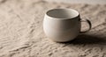 Ceramic mug with a round shape and a small handle is placed on a Royalty Free Stock Photo