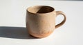 Ceramic mug with a rounded shape and a smooth handle. Made of speckled beige Royalty Free Stock Photo