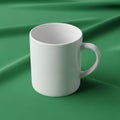 Ceramic mug with a simple, smooth design placed against a green fabric Royalty Free Stock Photo