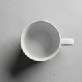 Ceramic mug with a smooth surface, set against a light gray, textured Royalty Free Stock Photo