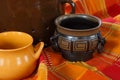 Ceramic mugs on decorative tablecloth, retro