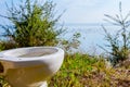 Outhouse toilet concept, bowl is placed in the forest above seas Royalty Free Stock Photo