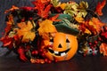 Ceramic Orange Halloween Pumpkin with Artificial Colorful Leaves Royalty Free Stock Photo