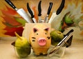 Ceramic pig in a tray for frying, surrounded by vegetables Royalty Free Stock Photo