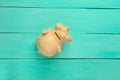 Ceramic piggy bank on a blue wooden background. Top view Royalty Free Stock Photo
