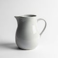Ceramic pitcher with a glossy finish is centered against a plain Royalty Free Stock Photo