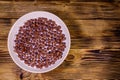 Ceramic plate with chocolate cereal balls in milk on wooden table. Top view Royalty Free Stock Photo