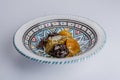 Ceramic plate with multicolor decoration with a delicious moroccan sweet dessert with prunes and dried apricots