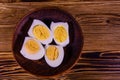 Ceramic plate with peeled boiled eggs on wooden table. Top view Royalty Free Stock Photo