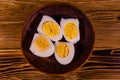 Ceramic plate with peeled boiled eggs on wooden table. Top view Royalty Free Stock Photo