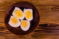 Ceramic plate with peeled boiled eggs on wooden table. Top view Royalty Free Stock Photo