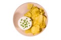 Ceramic plate with potato chips and glass bowl with sour cream isolated on a white background Royalty Free Stock Photo