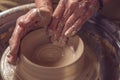 Ceramic plate on a potter's wheel, ceramist's hands. Royalty Free Stock Photo