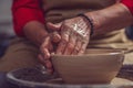 Ceramic plate on a potter's wheel, ceramist's hands. Royalty Free Stock Photo