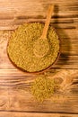 Ceramic plate and spoon with fenugreek seeds on wooden table. Top view Royalty Free Stock Photo