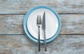 Ceramic plates, fork and knife on wooden table, top view Royalty Free Stock Photo