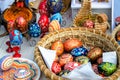 Ceramic plates, hand-painted wooden souvenirs are on the counter at the festive fair.