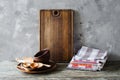Ceramic plates, wooden or bamboo cutlery, vintage cutting board and towels in interior of kitchen