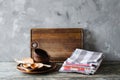 Ceramic plates, wooden or bamboo cutlery, vintage cutting board and towels in interior of kitchen