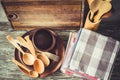 Ceramic plates, wooden or bamboo cutlery, vintage cutting board and towels in interior of kitchen