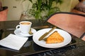 Ceramic, porcelain coffee cup - cappuccino, mochaccino. Piece of cake on saucer.