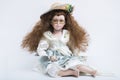 Ceramic porcelain handmade blond doll with wicker hat and yellow glasses Royalty Free Stock Photo