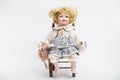 Ceramic porcelain handmade doll with big blue eyes and curly blond hair Royalty Free Stock Photo