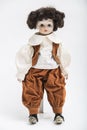 Ceramic porcelain handmade doll of a brunette boy in brown costume Royalty Free Stock Photo