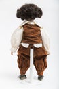 Ceramic porcelain handmade doll of a brunette boy in brown costume Royalty Free Stock Photo