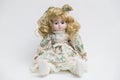 Ceramic porcelain handmade doll with long blond hair and floral dress Royalty Free Stock Photo