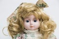 Ceramic porcelain handmade doll with long blond hair and floral dress Royalty Free Stock Photo