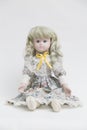 Ceramic porcelain handmade doll with long white hair and floral dress Royalty Free Stock Photo