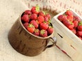 Ceramic pot full of fresh red strawberries, wooden crates Royalty Free Stock Photo