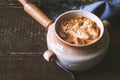 Ceramic pot with onion soup on the wooden table horizontal Royalty Free Stock Photo