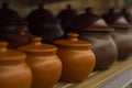Ceramic pots for baking are on the shelf in a row to bake Royalty Free Stock Photo