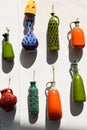 Ceramic pots hanging outside a white wall