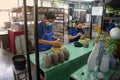 A ceramic potter is carving a pattern on the ceramic gelatin.