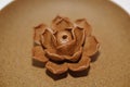 Ceramic rose on ceramical plate.