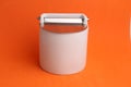 Ceramic salt shaker isolated on an orange background