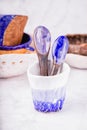 Ceramic set on a white marble background. White, blue and brown colors. Cups, spoons, bowls. Handmade Royalty Free Stock Photo