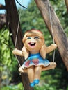 Ceramic Smiley Girl Doll On A Swing