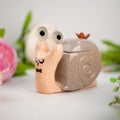 Ceramic snail with big eyes in the garden Royalty Free Stock Photo