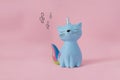 Ceramic souvenir toy moneybox kitten Korn blue with colorful rainbow tail with closed eyes and unicorn horn on pink