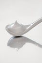 Ceramic spoon with cream, close, white mousse