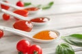 Ceramic spoons and bowls with different sauces on table, closeup Royalty Free Stock Photo